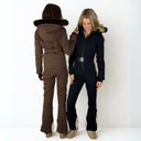 Two women wearing brown and black skiing suits on a white background